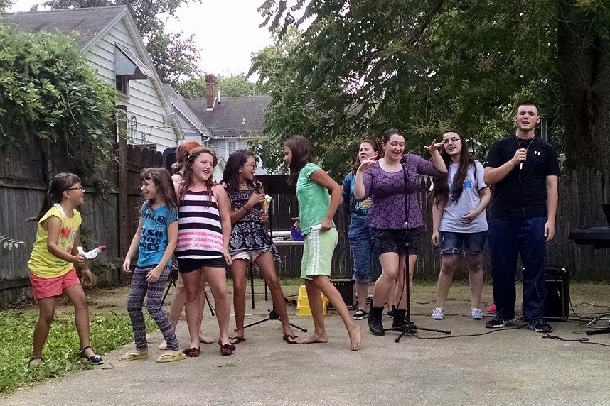 A group of kids sing at a talent show.