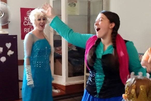 Ana and Elsa sing along at the library.
